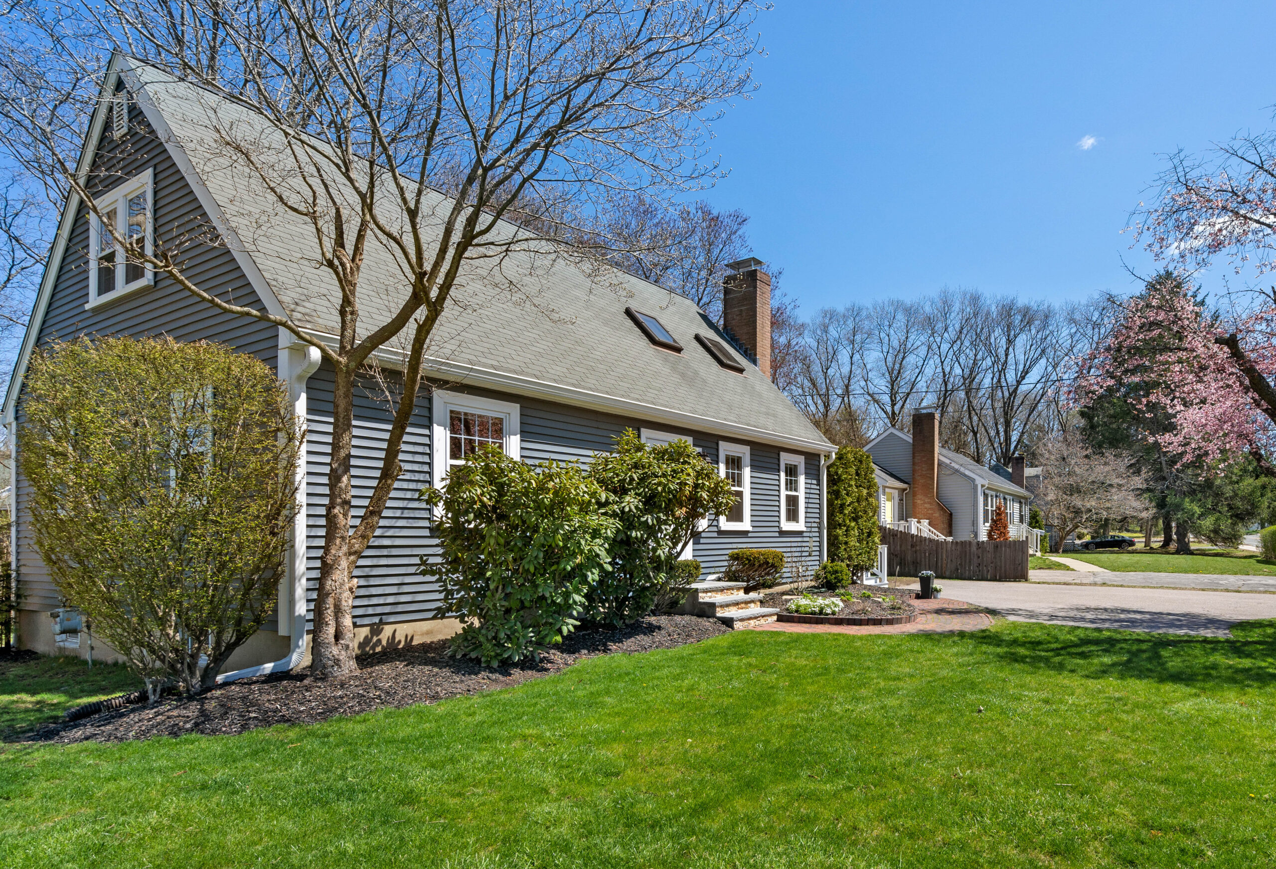 Blue Cape-style home in Needham MA with classic New England curb appeal and residential neighborhood setting