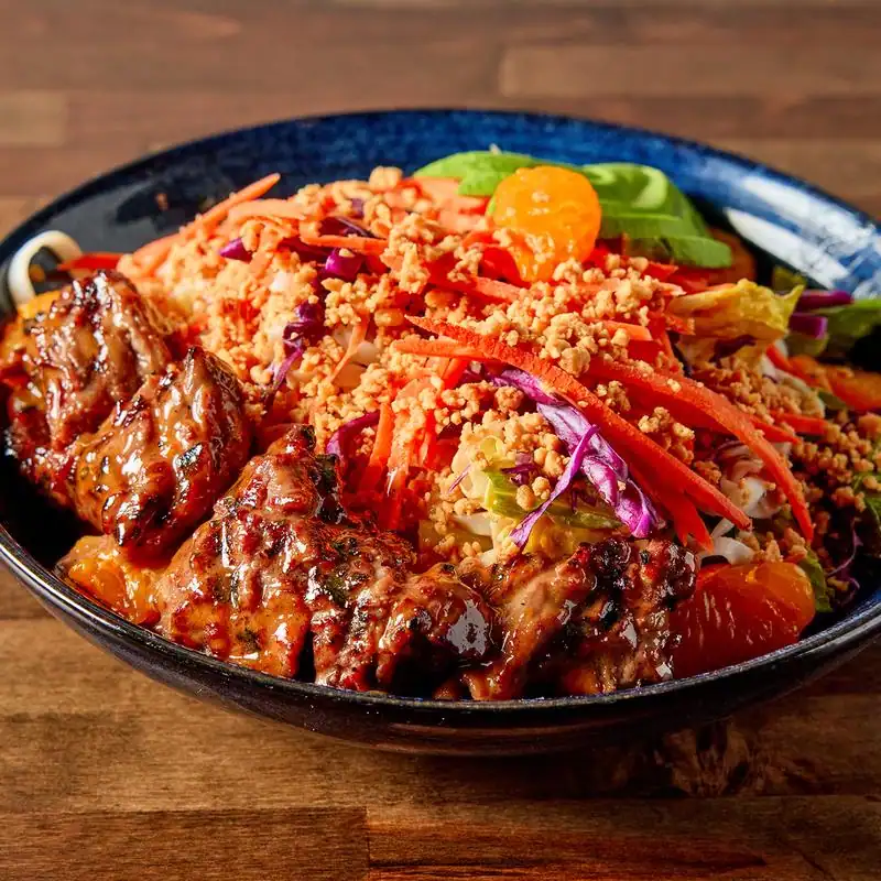 Healthy grilled chicken served with fresh vegetable salad.